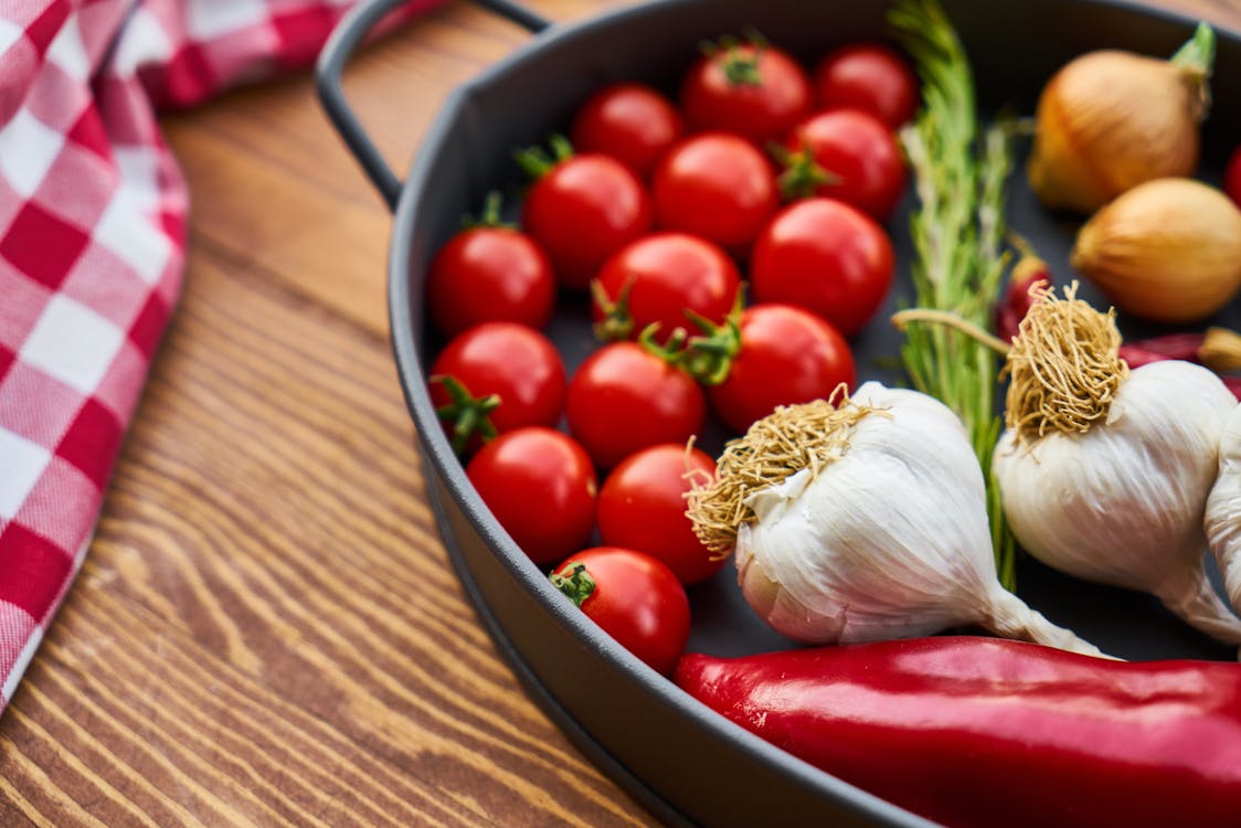 Free Red Tomatoes and Garlics in Cooking Pot Stock Photo