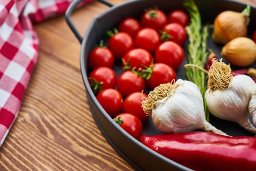 Red Tomatoes and Garlics in Cooking Pot