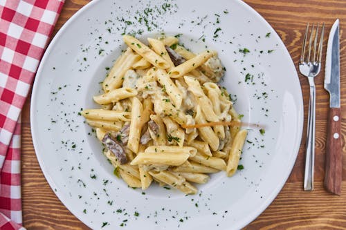 Free Flat Lay Photography of Pasta Served in White Plate Stock Photo