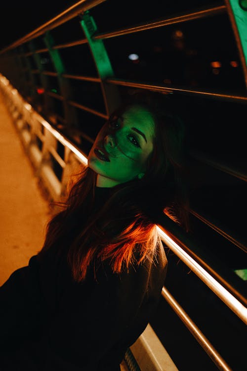 Woman Posing on Bridge at Night
