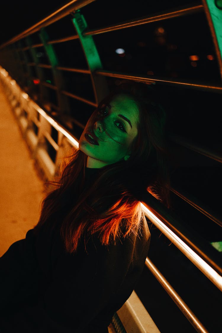 Woman Posing On Bridge At Night