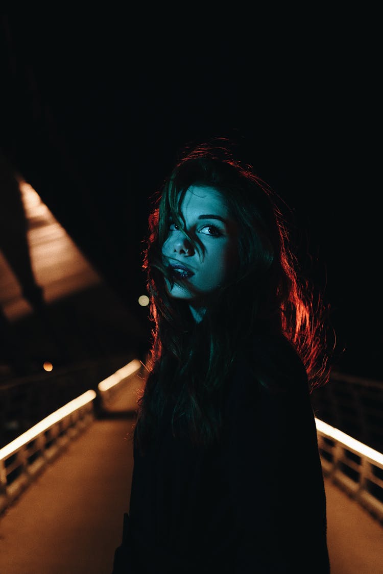 Woman Posing On Bridge At Night