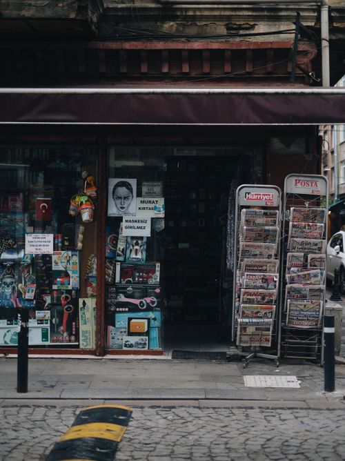 Free Cozy corner on a Turkish street featuring a newsstand and inviting local shop. Stock Photo