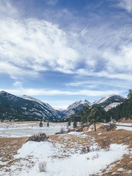Breathtaking view of snowy mountains under a bright blue sky in winter.