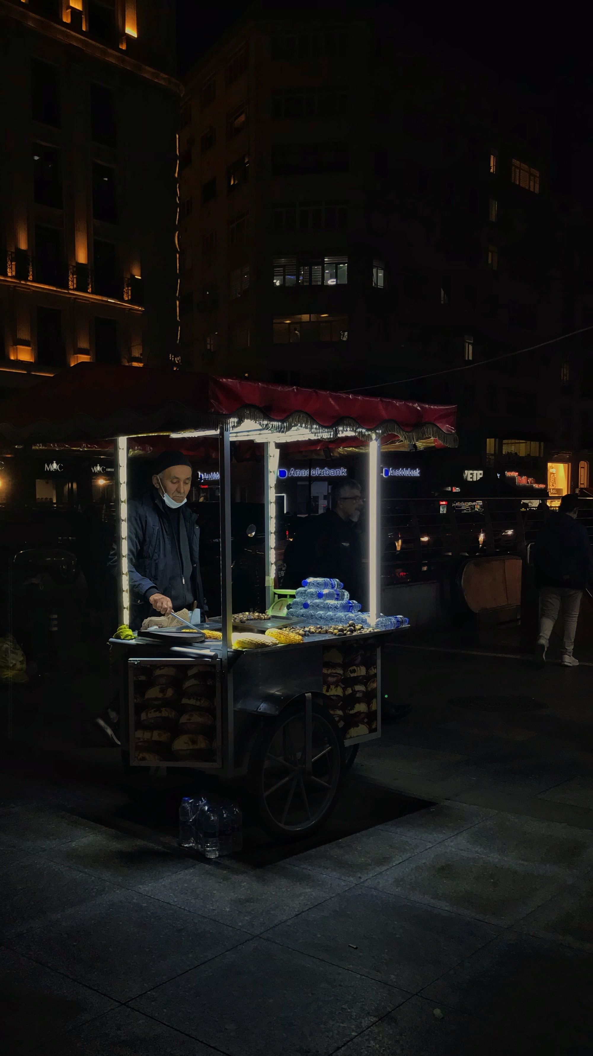 Explore the vibrant night scene with a street food vendor in Istanbul, showcasing Turkish culture.