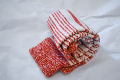Rolled red and bone striped crew socks, photo by Victoria Farr on Pexels
