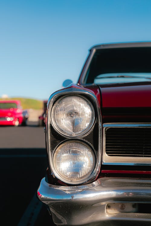 A Red Vintage Car with Round Headlights 