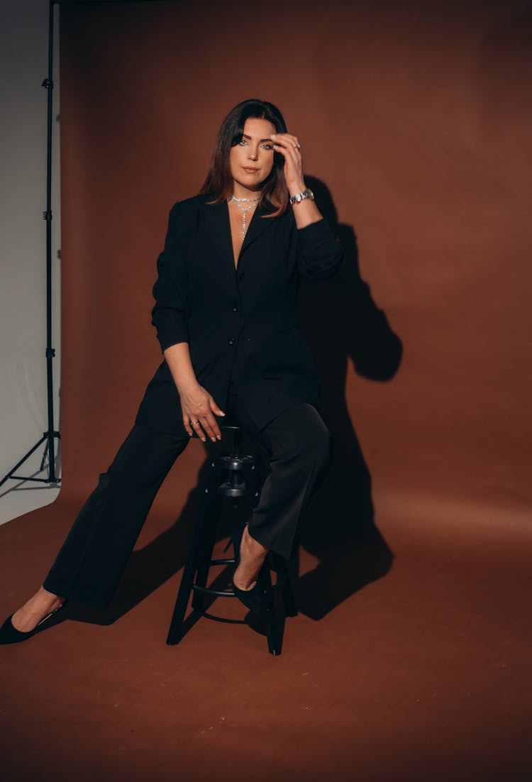 Woman In Suit Posing In Photo Studio