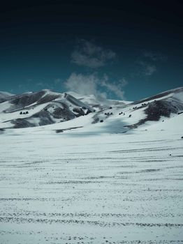 Serene snow-covered hills in Semnan, Iran. Capturing the tranquil winter landscape and natural beauty.