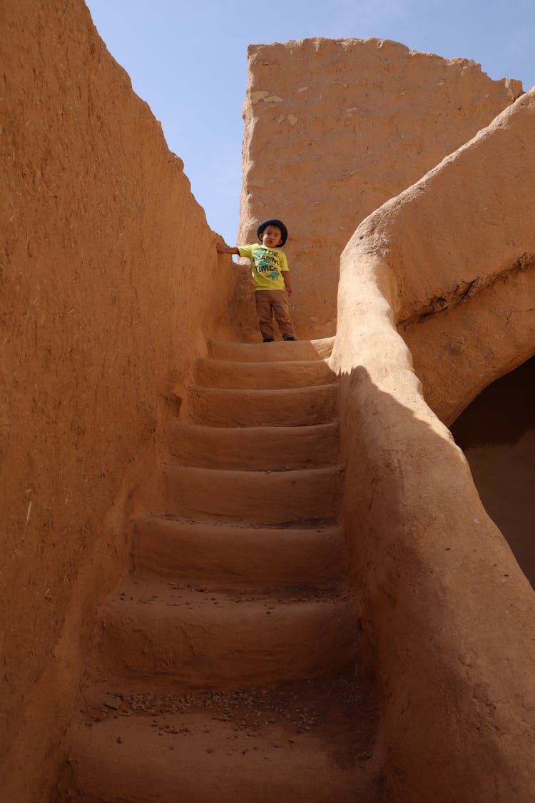 Boy Standing On Stairs