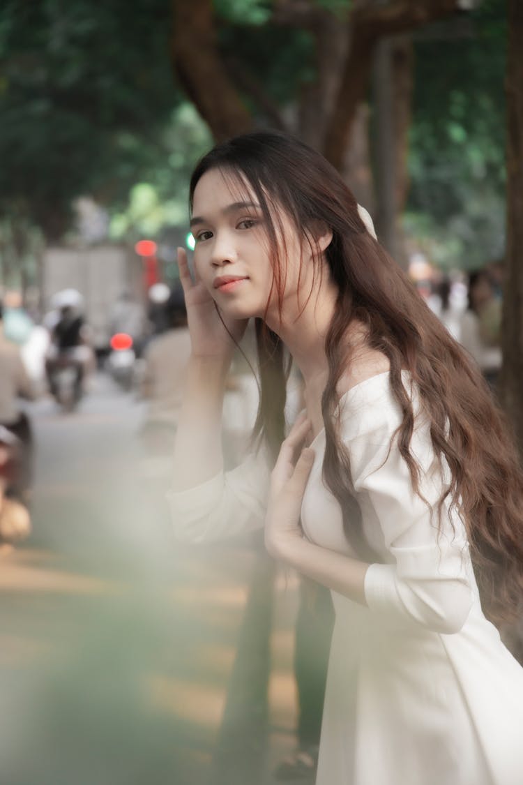 Teenage Girl In White Dress Standing On A Park