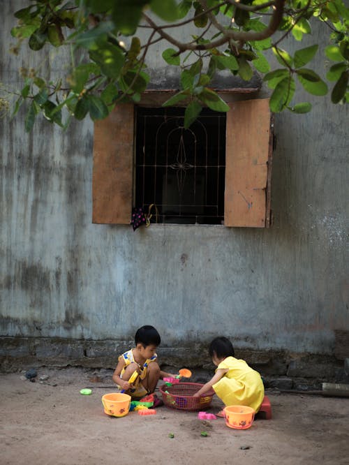 Two Young Kids playing Toys Together 