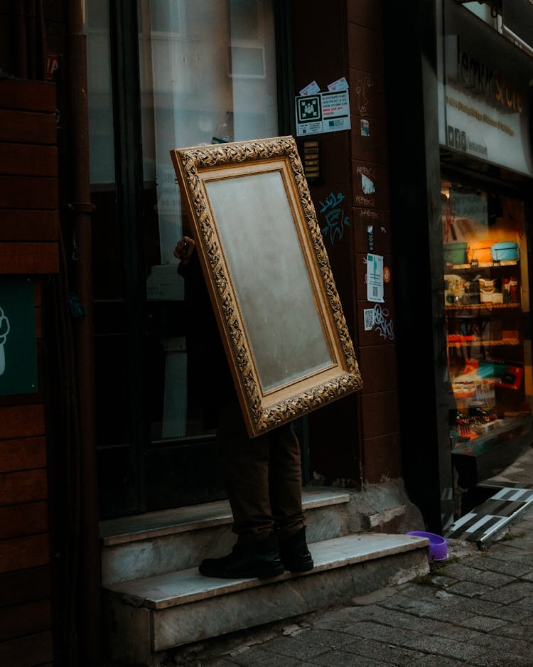 Man Carrying Painting Frame