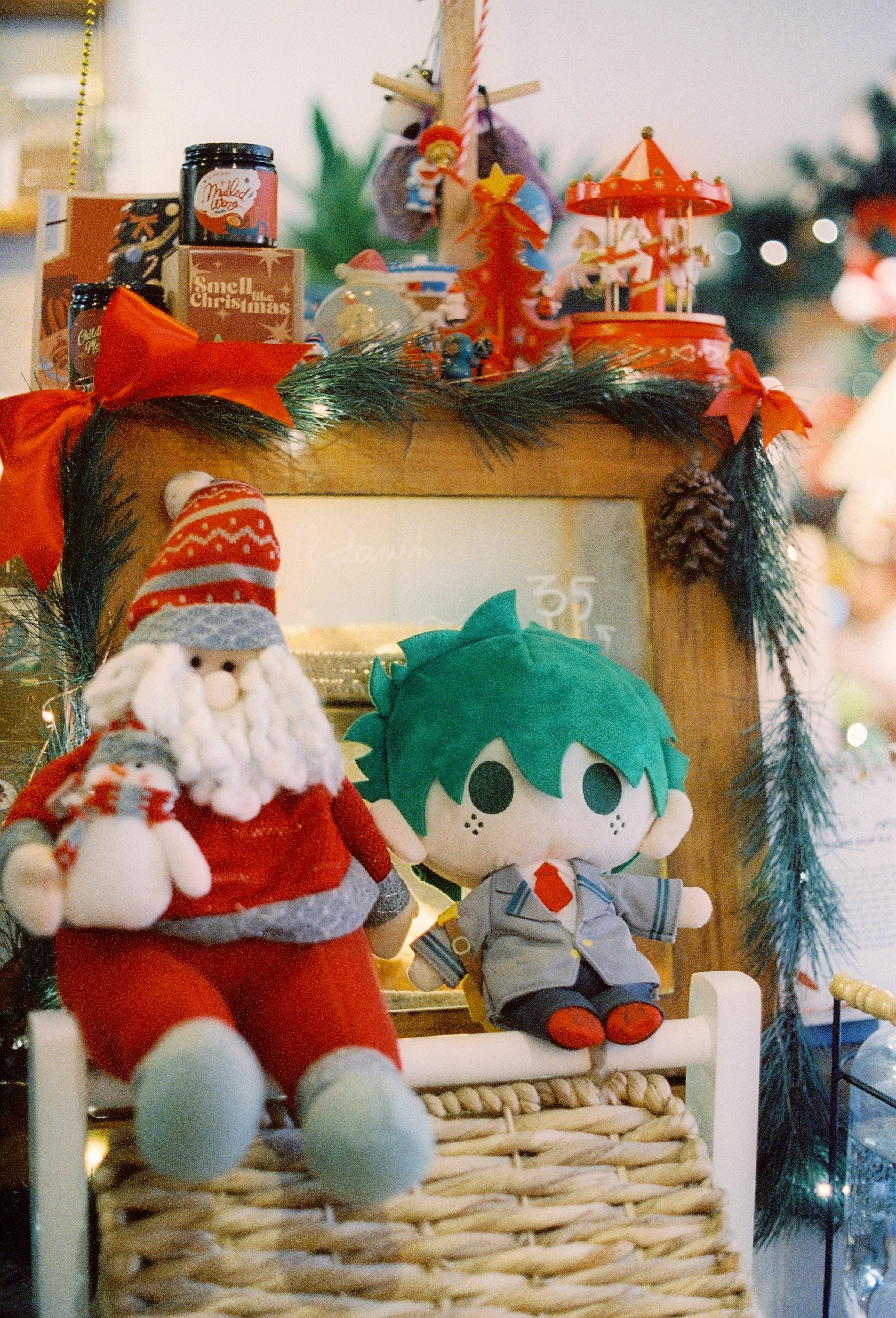 santa claus stuffed toy beside my hero academia stuffed toy