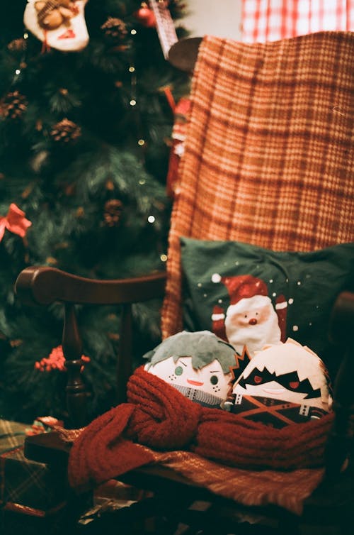 Dolls on Chair next to Christmas Tree