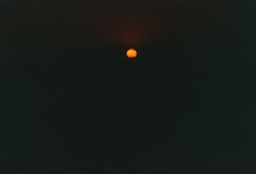 A dramatic view of a red full moon against a dark night sky, perfect for nightscape themes.