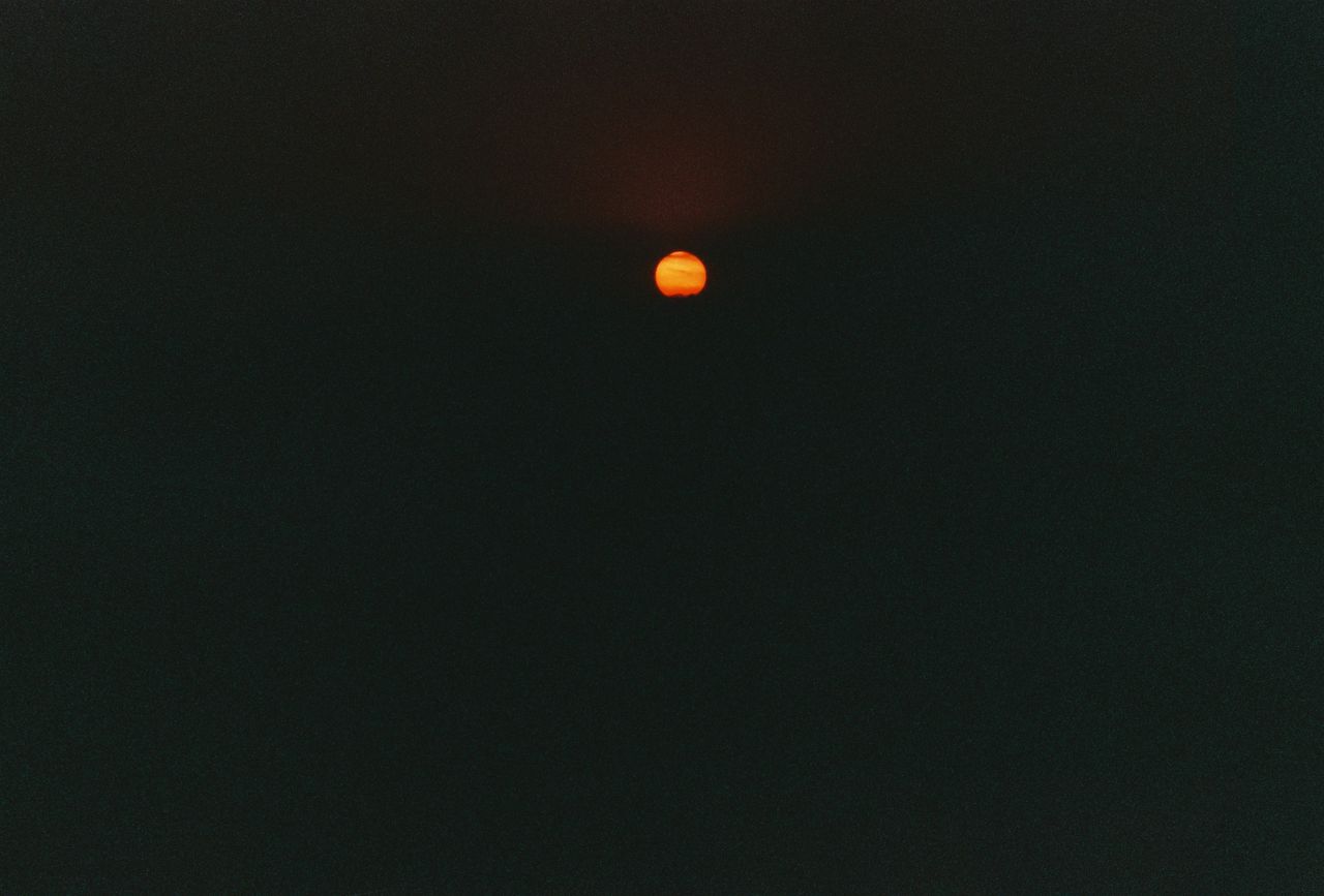 a dramatic view of a red full moon against a dark night sky perfect fo