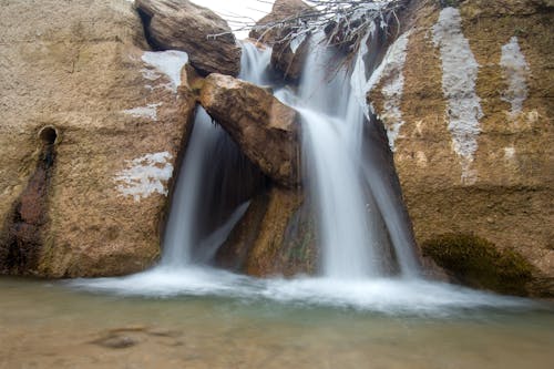 Beautiful Waterfalls Flowing from Brown Rocks