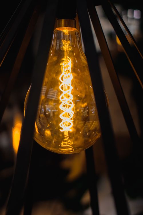 Free Warm glow of a vintage Edison light bulb with visible filament, perfect for mood lighting concepts. Stock Photo