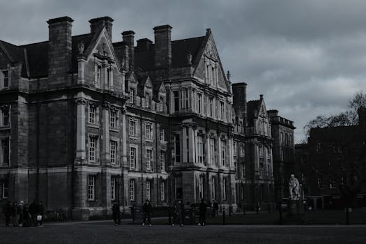 Gothic architecture of Trinity College, Dublin under moody clouds.