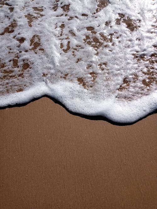 A Seafoam on Brown Sand