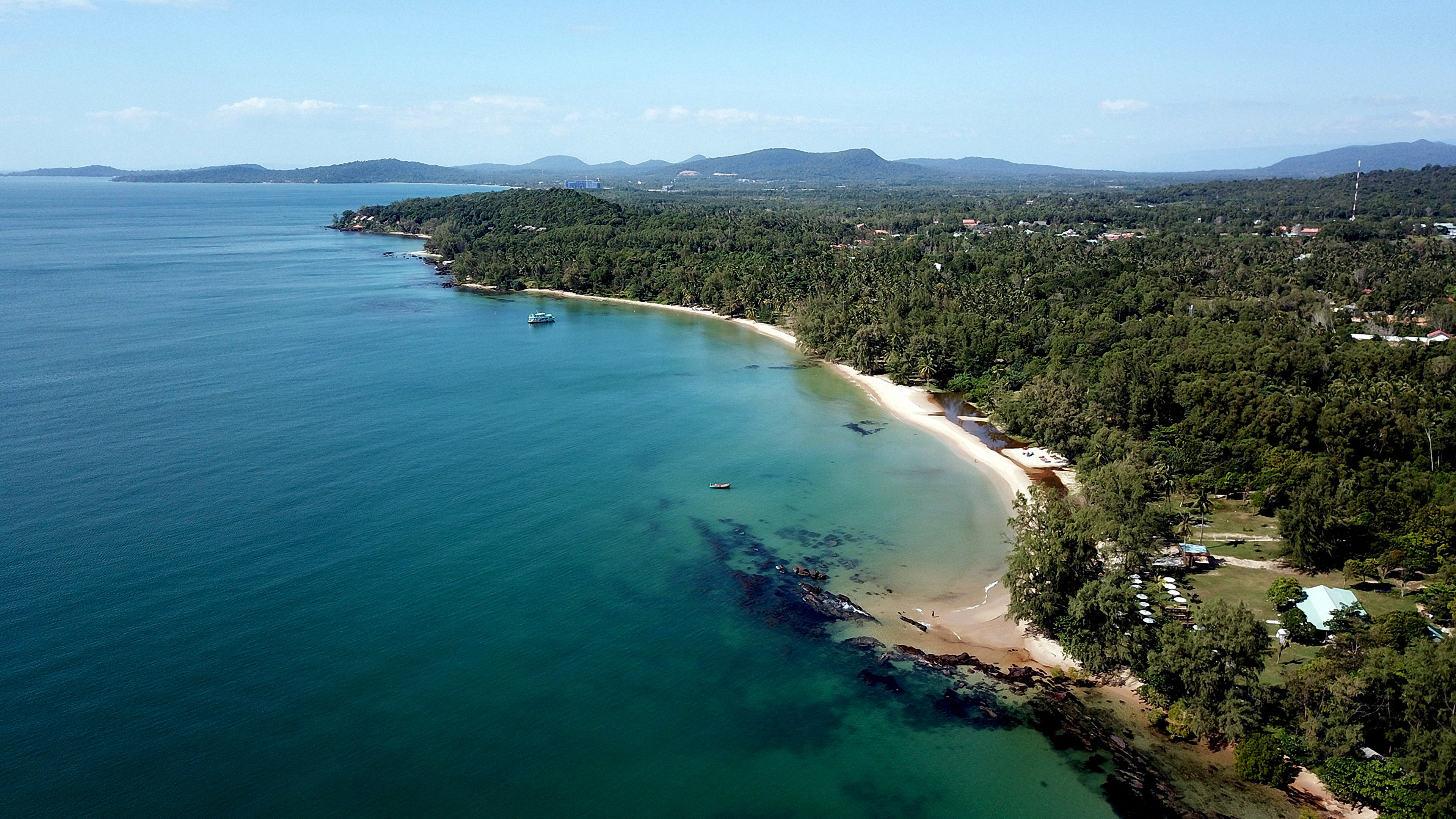 Serene aerial view of a tropical beach surrounded by lush greenery in Gia Lai, Vietnam.