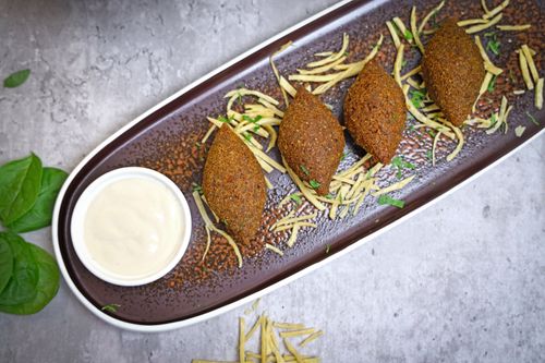 Free Top view of delicious falafel served with creamy dip and garnish on a rustic plate. Stock Photo