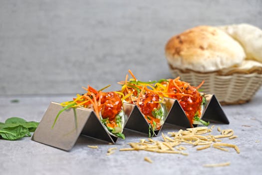 Mouth-watering spicy tacos topped with fresh vegetables and served with bread.