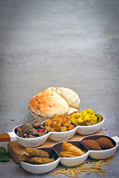 A tray of food with bread and a bowl of rice