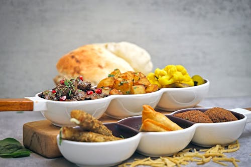 A plate of food with bread and a bowl of salad