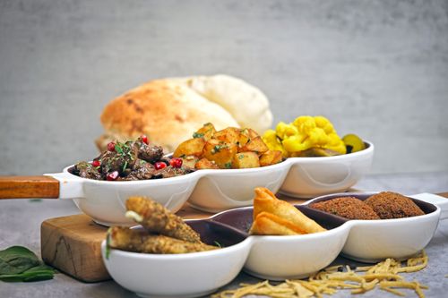 Free Middle Eastern appetizer platter with various dishes and breads, perfect for sharing. Stock Photo