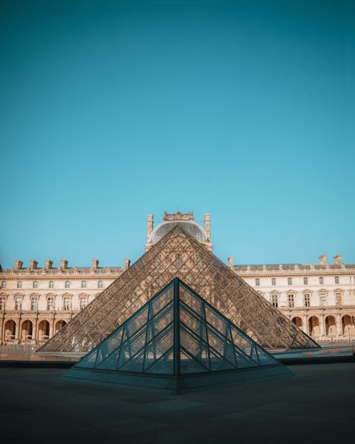 Facade of the Louvre and the Pyramid in Paris, France 