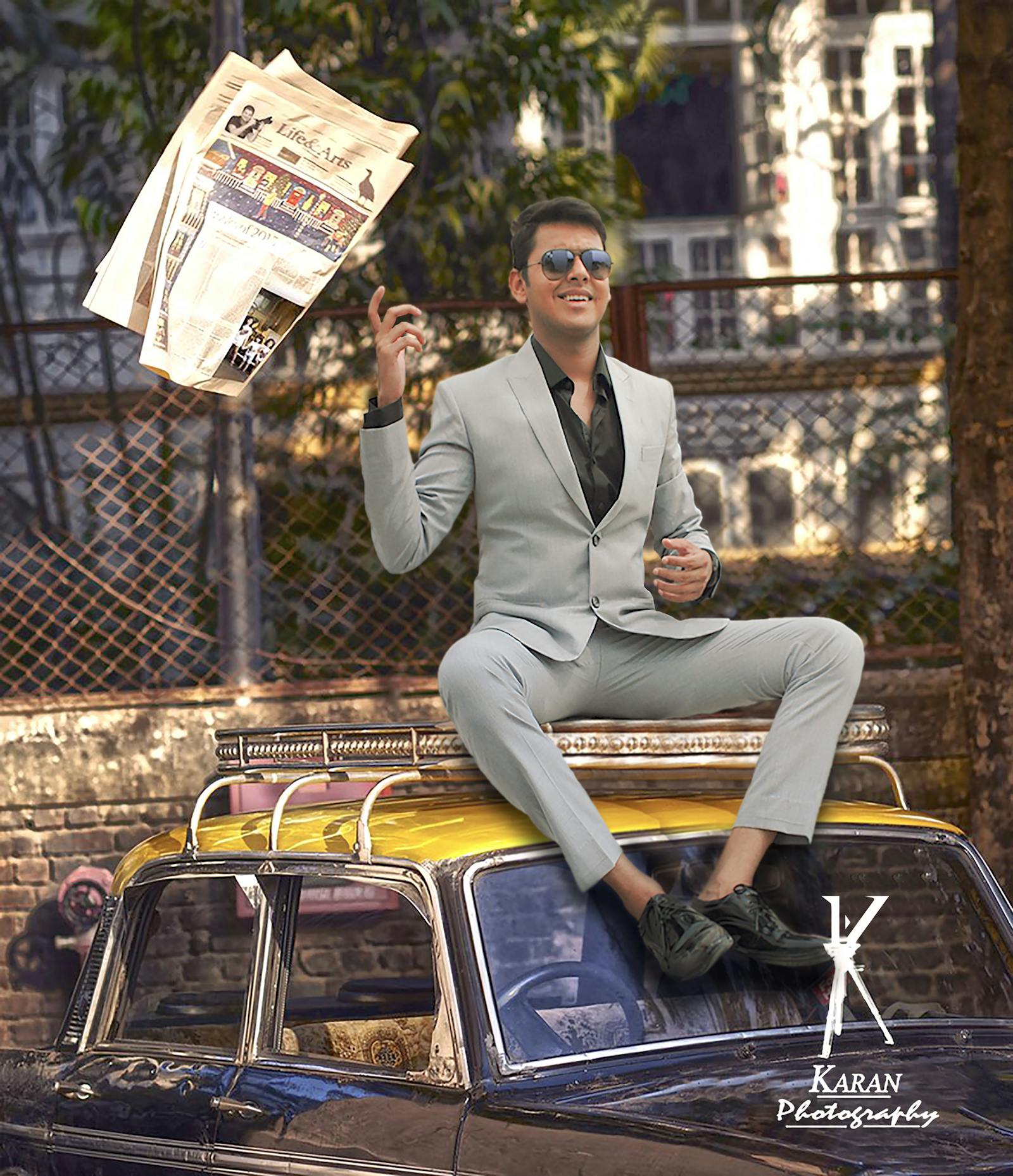 Two women sitting on a bench looking at a city skyline at sunset