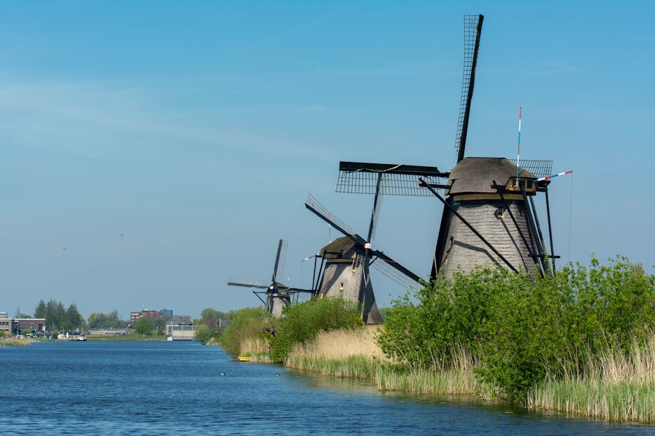 Traditional windmills along the canal in Kinderdijk, Netherlands, showcasing classic Dutch countryside beauty