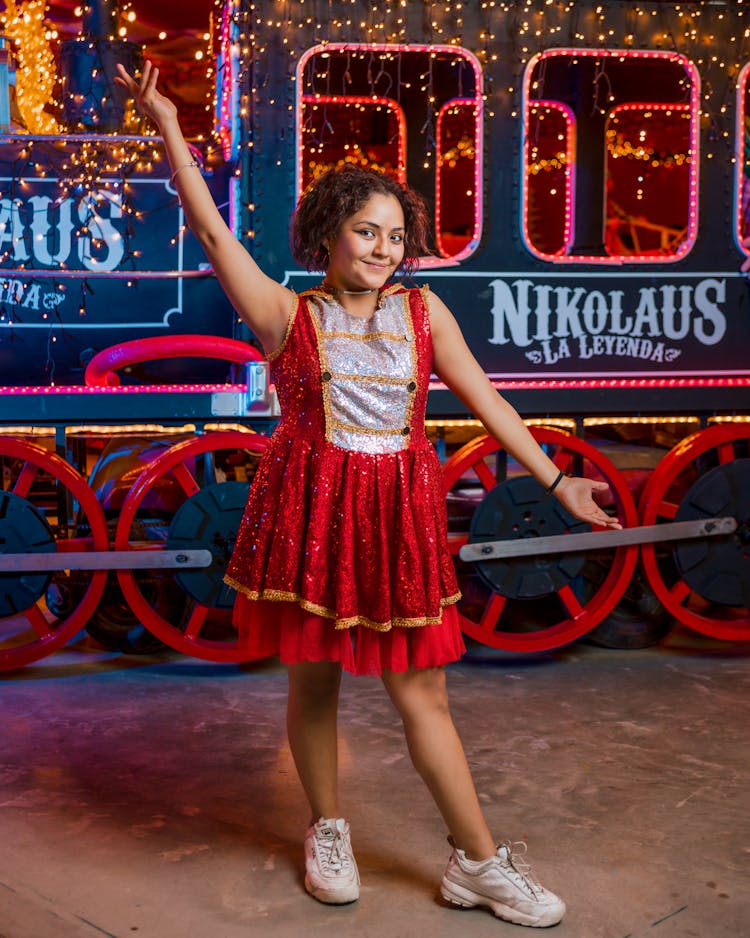 Woman Posing In A Sparkly Costume By A Locomotive