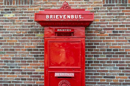 An Old Dutch Red Letter Box against a Brick Wall 