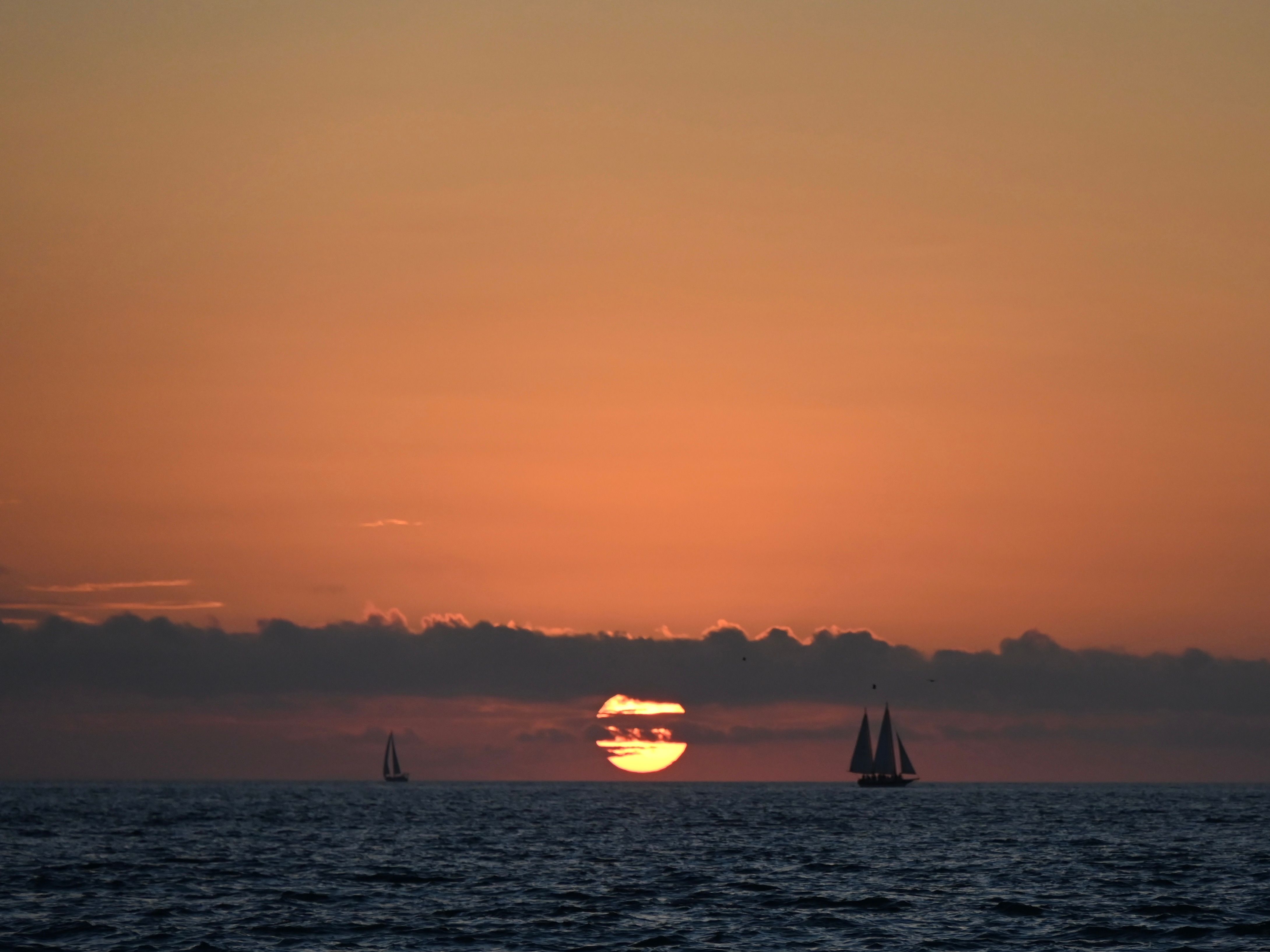 Silhouette of Sailboats on Water During Sunset · Free Stock Photo