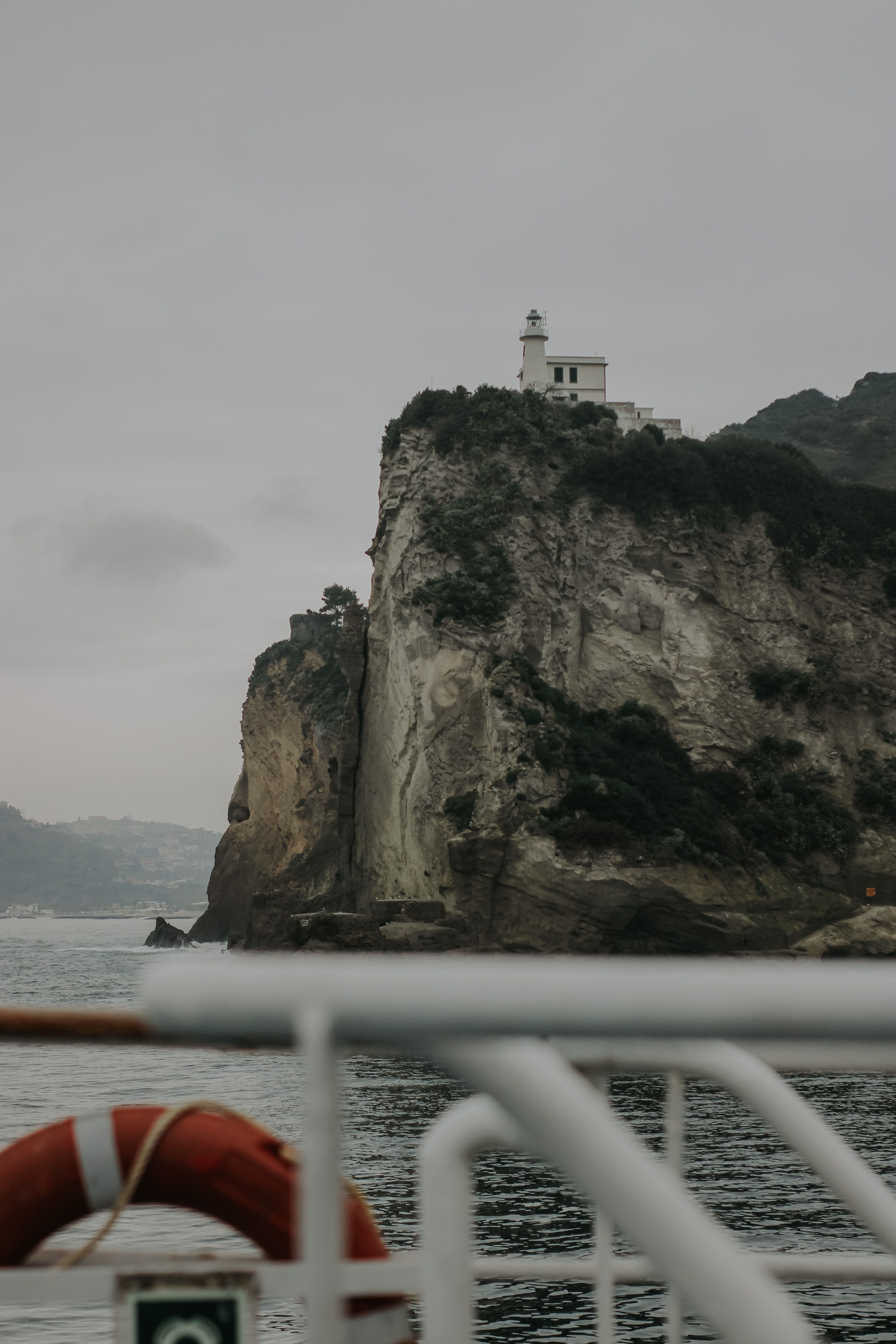 Lighthouse perched atop Cape Miseno's dramatic cliffs, a symbol of coastal navigation.