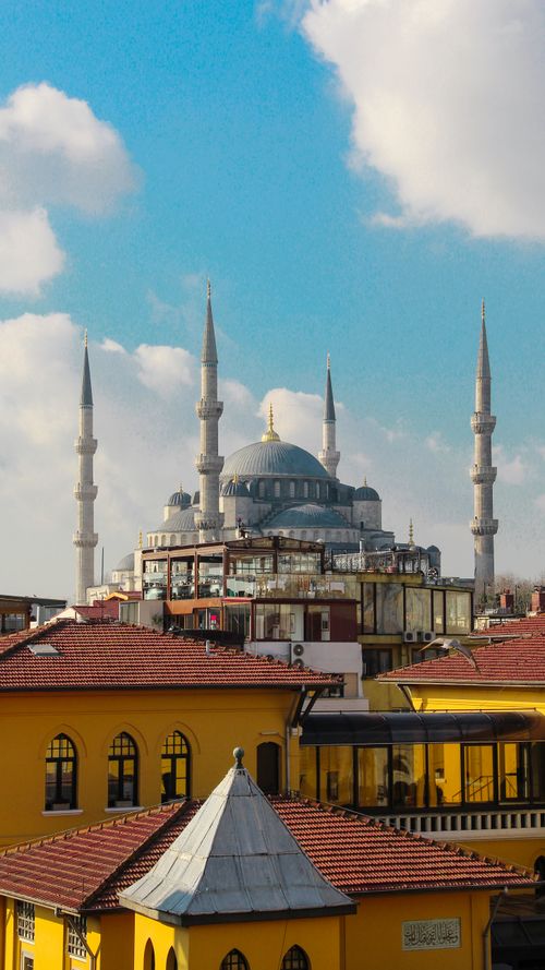 Free Stunning view of Sultan Ahmed Mosque amidst the vibrant rooftops of Istanbul with clear blue skies. Stock Photo