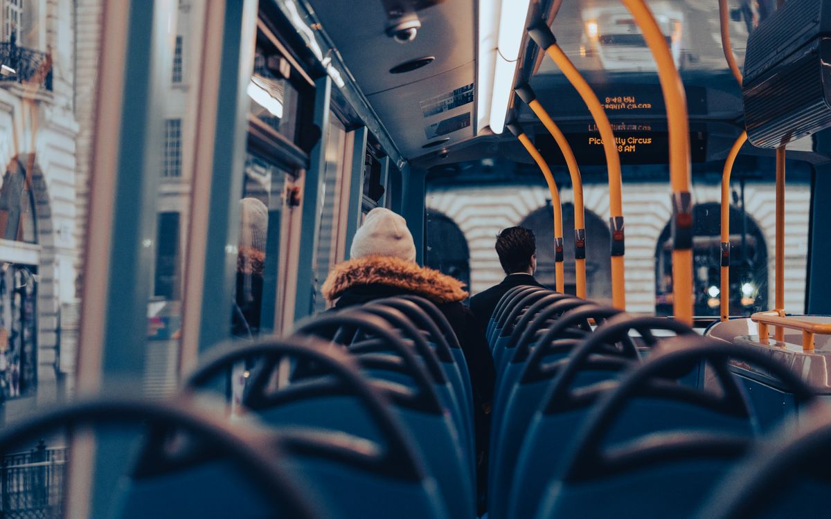 Passengers traveling on a city bus through London, capturing urban commuting life.