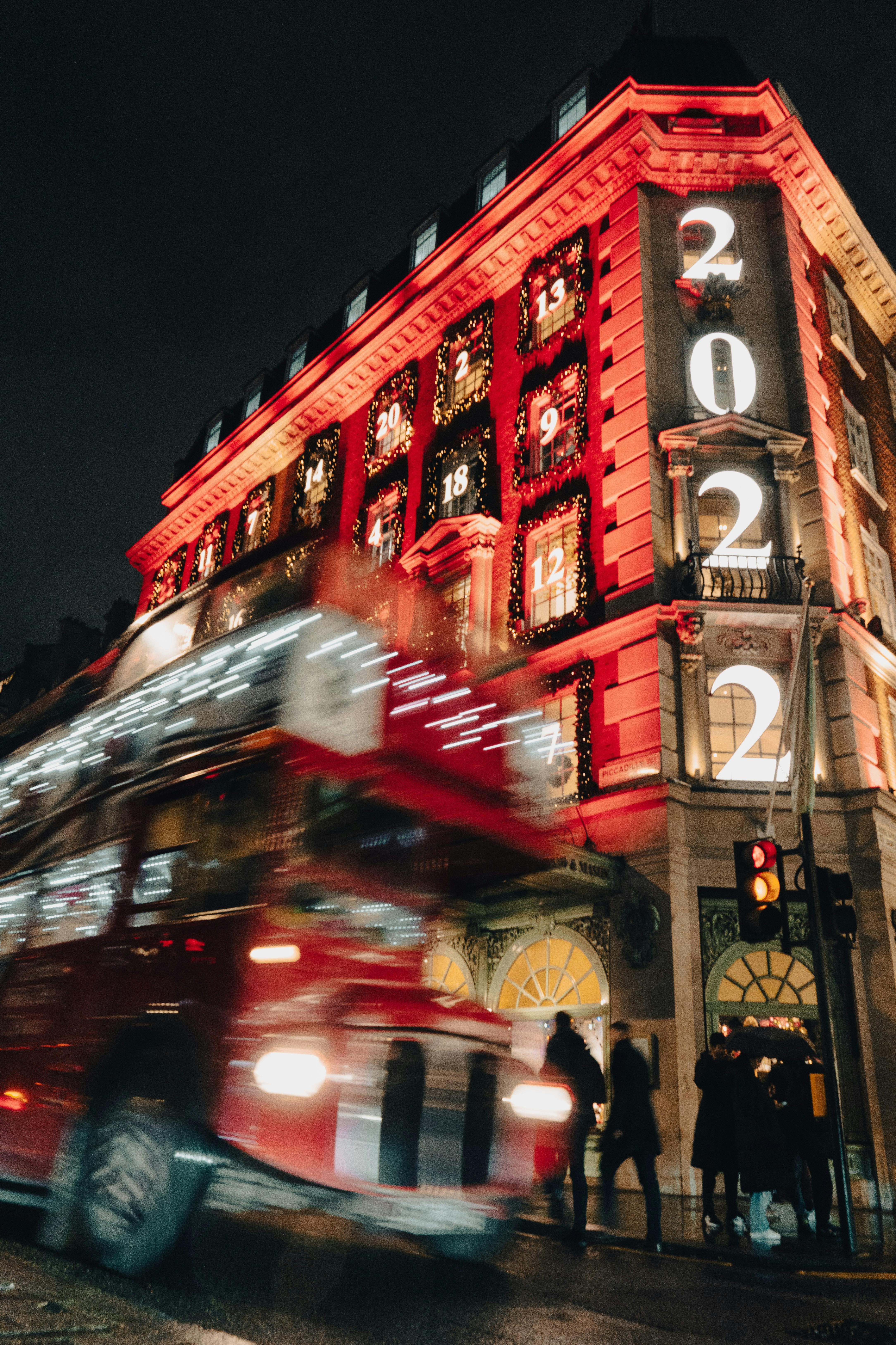 blurred motion of a bus in front of an illuminated fortnum mason department store in london england