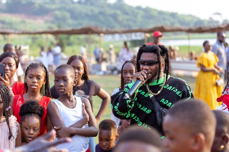 A Singer Among A Crowd On A Festival 