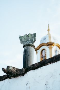 Close-up view of a historic church tower in Tiradentes, Brazil, featuring detailed architectural elements.