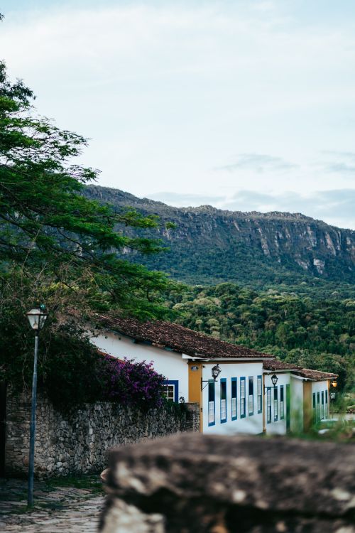 Free Idyllic view of colonial houses beneath lush mountains in Tiradentes, Brazil. Perfect travel scenery. Stock Photo
