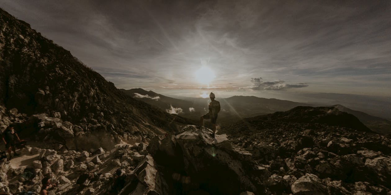 A Man Standing on Top of the Mountain