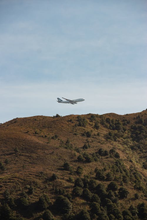 Airplane Flying over a Mountain 