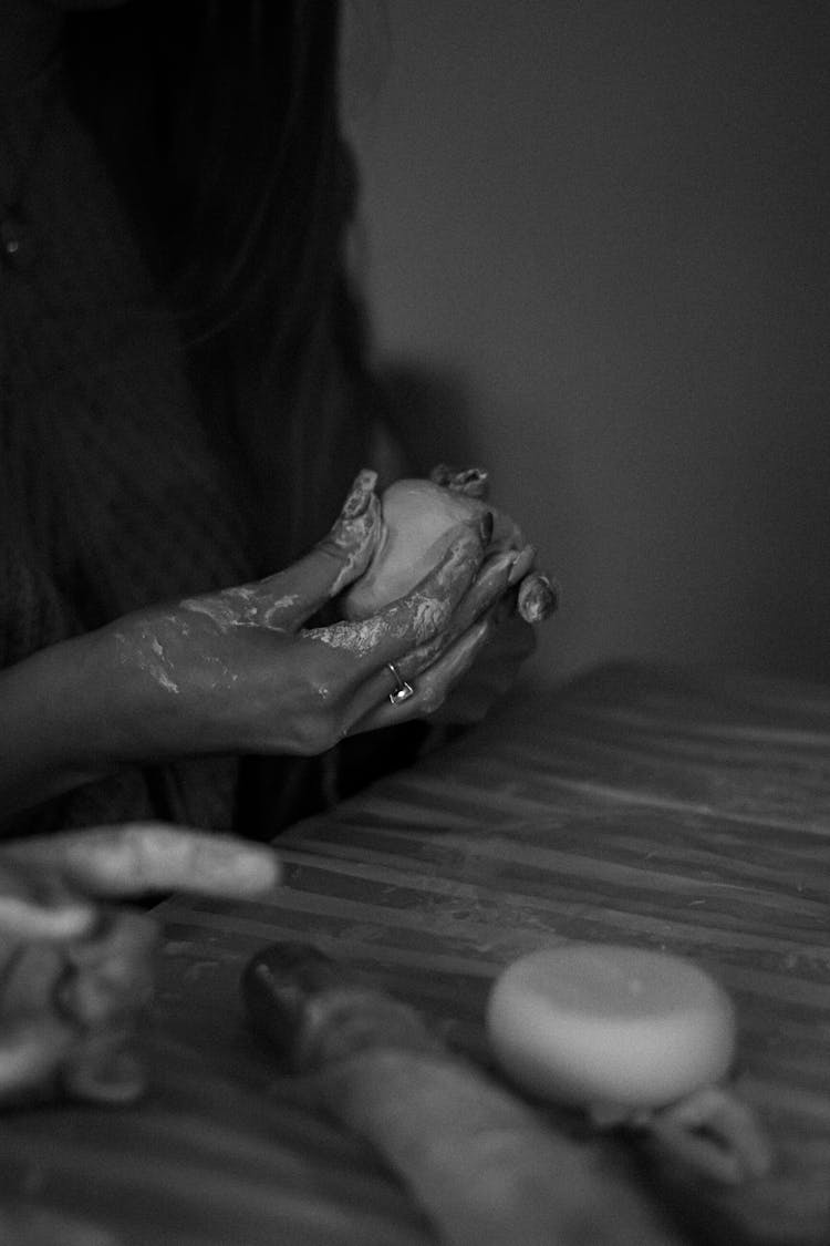 Person Shaping A Clay