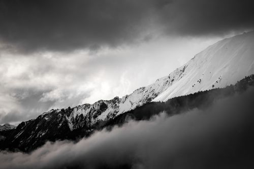 Free Dramatic black and white image of snow-capped mountains in Crans-Montana, Switzerland. Stock Photo