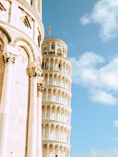 Free Capture the iconic Leaning Tower of Pisa under a bright blue sky; a blend of history and architecture. Stock Photo