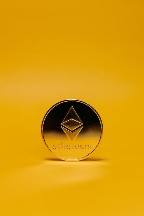 Free Ethereum Coin on Yellow Background Stock Photo